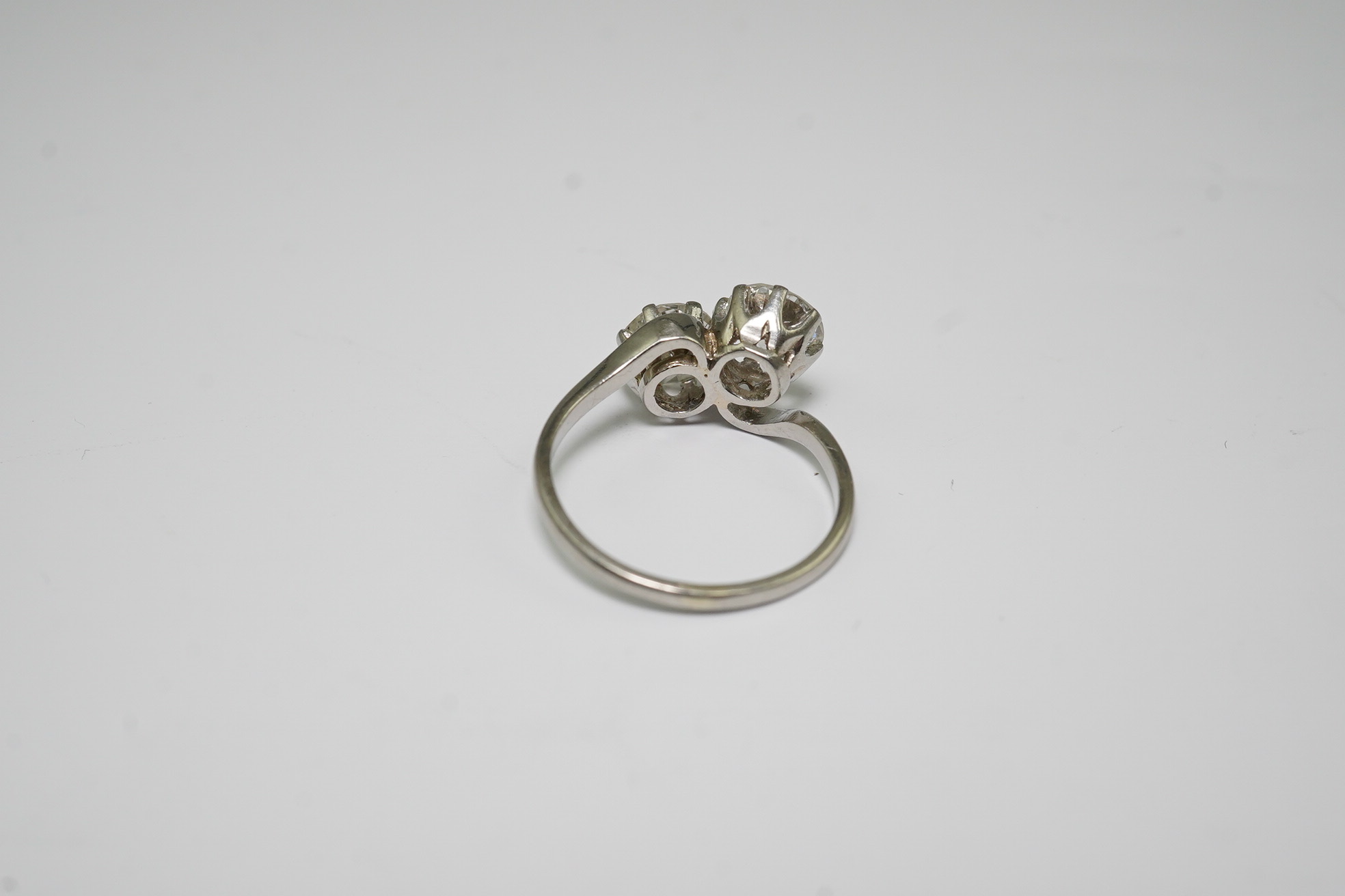 A platinum? and two stone diamond set crossover ring